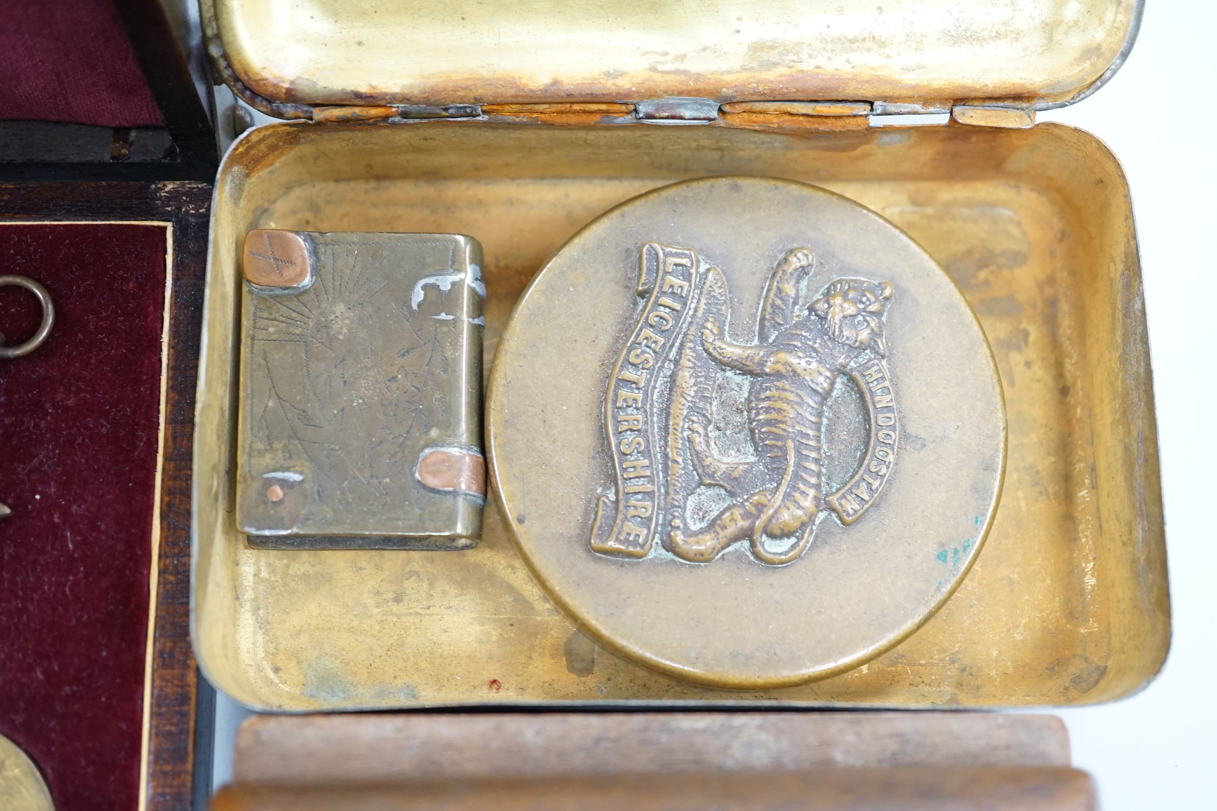 A quantity of war medals, Leicestershire brass paperweight, a carved box Somme Trench art match case and a gilt brass Christmas tin